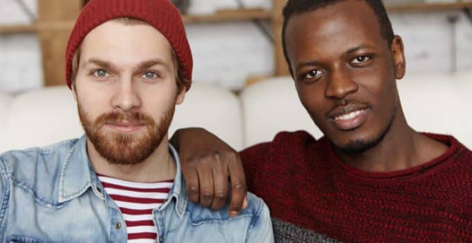 people love homosexuality samesex male couple spending nice time together cafe afro american man holding hand his caucasian partner s shoulder both looking smiling 273609 109