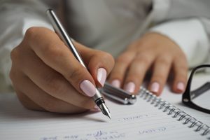 vrouw schrijven pen papier handschrift studeren student